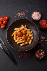Penne pasta with meatballs in tomato sauce with salt and spices. Italian food penne pasta