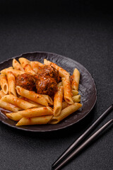 Penne pasta with meatballs in tomato sauce with salt and spices. Italian food penne pasta