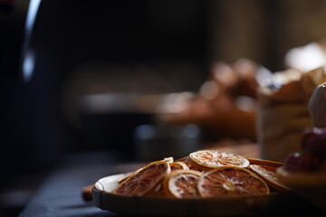 Close-up of traditional Asian dried herbs and ingredients in bamboo baskets, including shiitake mushrooms, jujube dates, and citrus slices. Organic natural food concept with soft background blur.