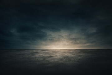 Fototapeta premium A vast and dark ocean under a dramatic cloudy sky with soft twilight light emerging from the horizon line. 