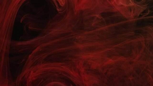 Ink smoke. Mystic fume. Red curly watercolor ink layers flowing in black deep water. Elegant veil defocused waving dye abstract background.