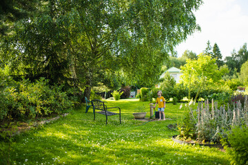 Adorable little boy having fun outdoors on sunny summer day. Kid running outdoors. Child exploring nature. Summer activities for kids.