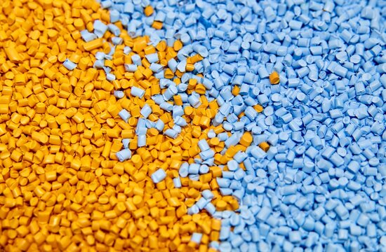 blue and yellow plastic polymer granules 