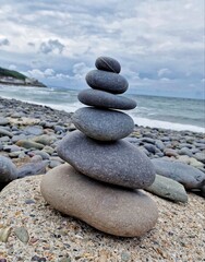 stones on the beach,Stone Tower on the Beach: Balance and Serenity.