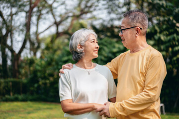 Obraz premium Asian Senior Couple Enjoying Time Together Outdoors Image of Older Man Woman Smiling Looking at Each Other Loving Relationship Happiness In Nature Backdrop