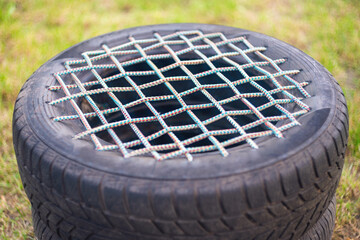 Garden chair made from an old car tire bound with rope. Reusing tires