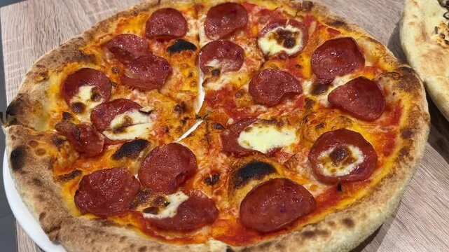 salami pizza on a wooden table