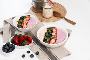 Presented by fruits putting yogurt toppings with strawberry, berry, oats, raisins and chia seed...