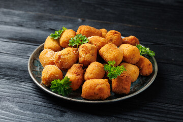 Deep fried potato croquettes with ham in a plate