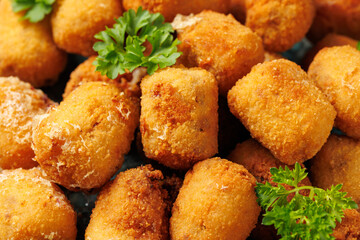 Deep fried potato croquettes with ham in a plate