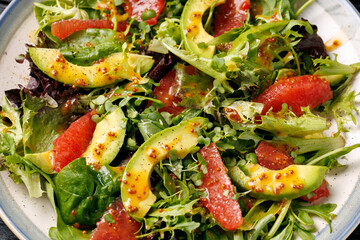 Fresh salad with grapefruit, avocado and pomegranate seeds