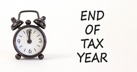 End of tax year symbol. Concept words phrase End of tax year on beautiful white paper. Black alarm...