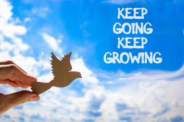 Keep going and growing symbol. Concept words phrase Keep going keep growing on beautiful blue sky....