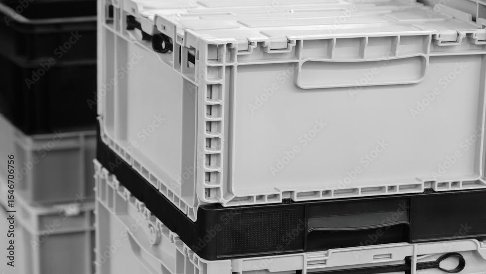 Poster stack of white boxes with black handles. the boxes are stacked on top of each other