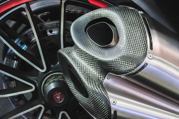 Pair of motorcycle exhaust pipes with a red rim. The exhaust pipes are silver and have a black...