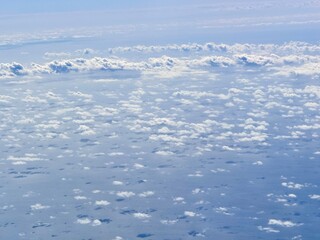 white clouds seen from an airplane above the sea and the Bahamas
