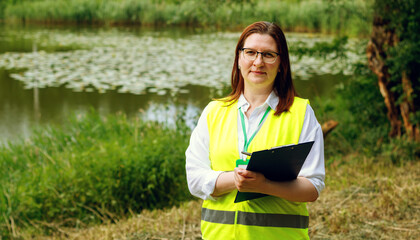 Female ecologist biologist European female forestry inspector studies the condition of trees near...