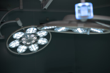 Close up view of powerful two white surgical lamps in modern dark sterile operating room, close up....