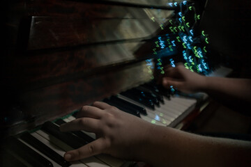The piano player hands, playing music abstract photography with notes shaped bokeh 