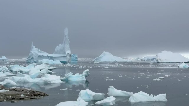 Big Iceberg in Antarctica Winter Scenery, Amazing Shape Ice Formation of Massive Large Enormous Blue Icebergs in Antarctic Peninsula Landscape Seascape with Ocean Sea Water