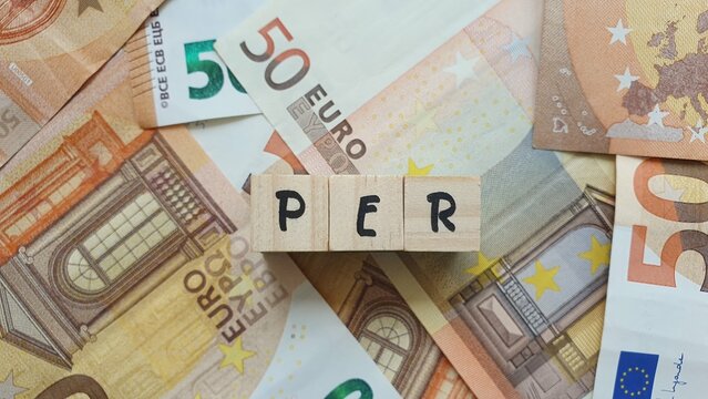 PER acronym made of wooden letter cubes on pile of Euro banknotes. Plan d&rsquo;&Eacute;pargne Retraite (Retirement Savings Plan)