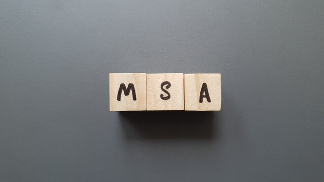 MSA acronym made of wooden letter cubes on dark background. Mutualité Sociale Agricole (Agricultural Social Security Fund) - Powered by Adobe