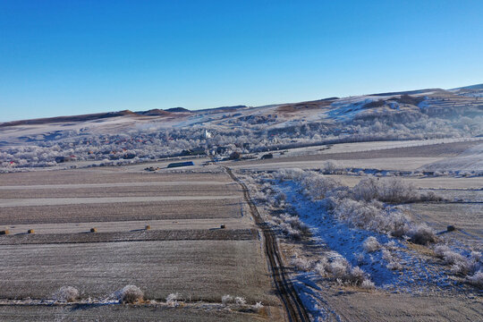 Aerial view of a misty countryside village, in early morning lights