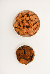 Spicy and salty crackers in cups. Bread snacks.