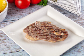 Grilled lamb steak with bone