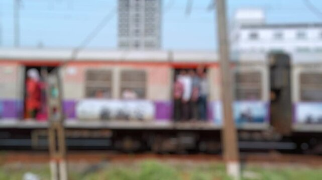 Bokeh view outside of moving suburban passenger train running to Mumbai, Maharashtra, India. Blurred background footage.