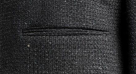 Close-up of a Black Textured Fabric with a Subtle Seam
