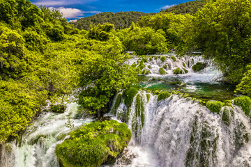 Closeup scenic view of Krka Waterfalls in Croatia, a renowned natural getaway known for its cascading waterfalls, scenic green waters, and outstanding setting in Dalmatia region