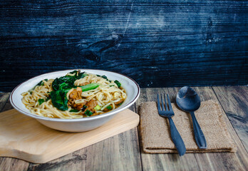 Indonesian street food culinary chicken noodles, noodles served with a mixture of sweet chicken...