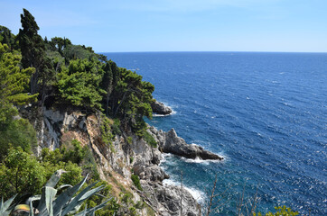 A stunning view of the Adriatic coastline in Dubrovnik, Croatia, showcasing the crystal-clear turquoise waters and rocky shoreline.