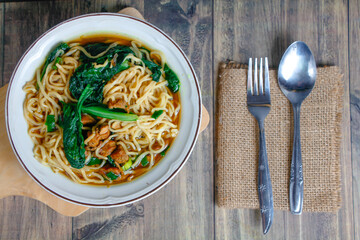 Indonesian street food culinary chicken noodles, noodles served with a mixture of sweet chicken...