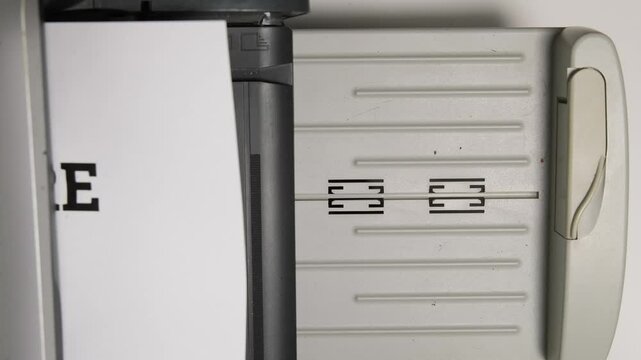 Close-up of a printer delivering a stark termination notice in a simple office environment