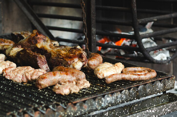 The typical argentinian barbecue with beef, chorizos, and sausages, and hot charcoal. 