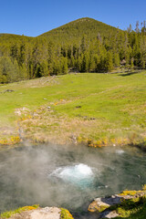 Scenic view of a spring of boiling water in the geothermal area of the Terrace Springs in Yellowstone National Park. No people.