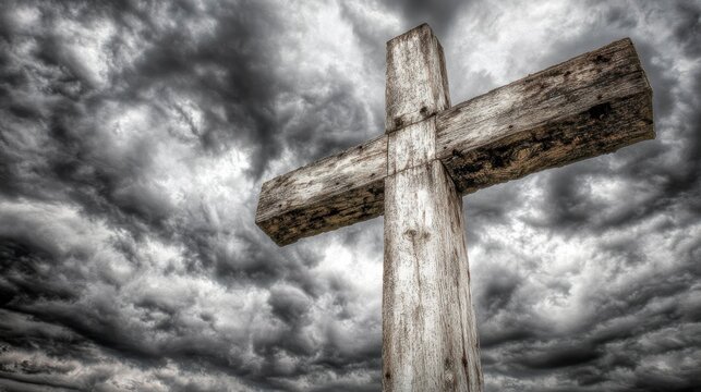 Weathered wooden cross against a stormy sky.