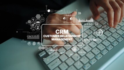Hands typing on keyboard with CRM customer relationship management graphics illustrating digital marketing concepts and data analysis. Asymptotic smart data analytic. - Powered by Adobe