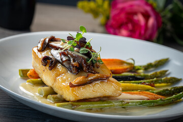 Miso Sea Bass with asparagus and carrots, topped with shiitake mushrooms.