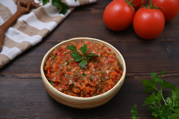 bowl with vegetarian dish of eggplant, pepper and tomatoes close-up