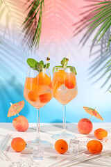 Modern still life with fruits. Royal lemonade cocktail with peach, apricot, mojito with tequila,...