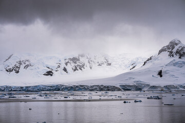 Beautiful paradise harbor in Antarctica under overcast sky
