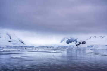 Beautiful paradise harbor in Antarctica under overcast sky
