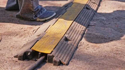Heavy Duty PVC Duct Ground Cable Cover Protector used to Prevent Trip Hazard in Outdoor Settings