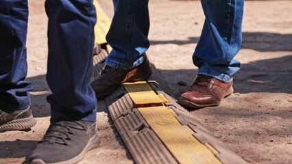 Heavy Duty PVC Duct Ground Cable Cover Protector used to Prevent Trip Hazard in Outdoor Settings