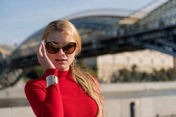 Woman in red dress enjoying a sunny day on the city street