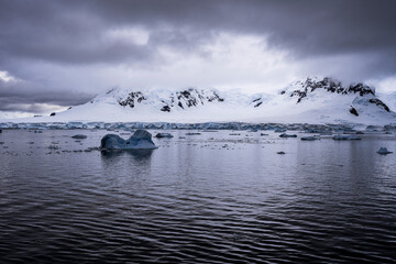 Beautiful paradise harbor in Antarctica under overcast sky