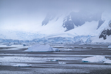 Beautiful paradise harbor in Antarctica under overcast sky